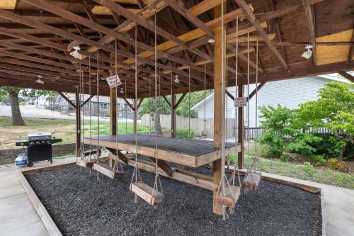a wooden pavilion with a picnic table and a grill at Lighthouse Lodge - Captain's Quarter - Boat Slip Access in Kimberling City