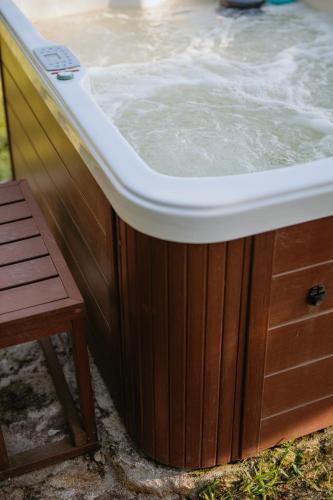 a wooden bath tub with water in it at Casa Malcata by Portus Alacer - Quinta Fonte Fria in Carreiras