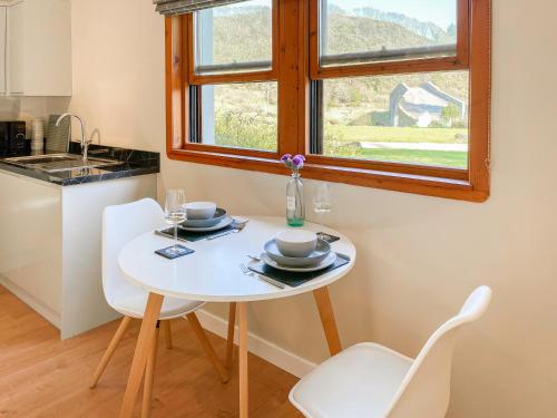 a small white table with two chairs and a window at Innish Beag - Uk38782 in Clachan