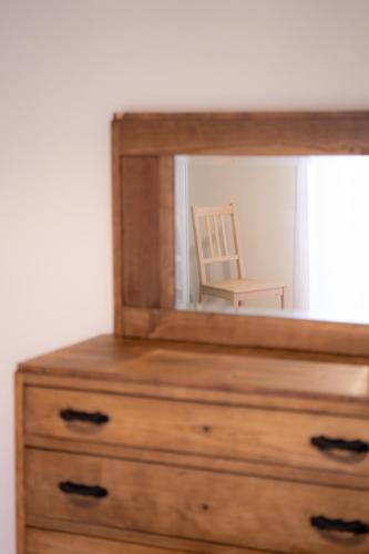 a mirror on top of a dresser with a chair at Tirituffo - B&B di campagna in Soveria Mannelli
