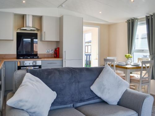 a living room with a couch and a kitchen with a table at Lodge 42 Bridlington Holiday Park - Uk48213 in Carnaby