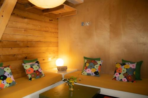 a room with pillows and a table with a lamp at Las Luciernagas Posada de Mar in La Pedrera