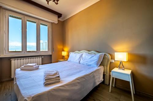 a bedroom with a bed with two towels on it at YD penthouse Torregalli in Scandicci
