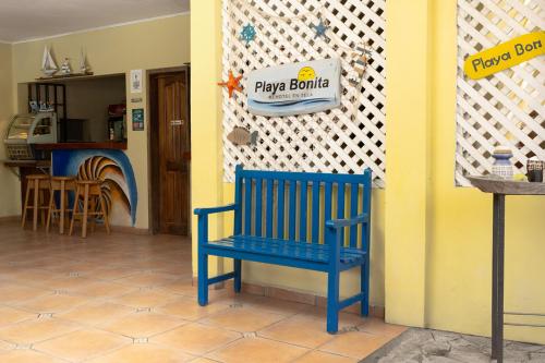 a blue bench sitting in front of a play room at Hotel Playa Bonita Tela in Tela