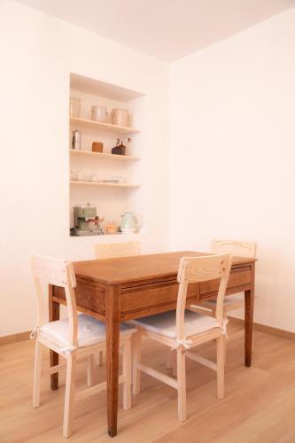 a dining room table with two white chairs around it at Tirituffo - B&B di campagna in Soveria Mannelli