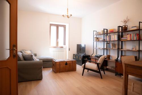 a living room with a couch and a book shelf at Tirituffo - B&B di campagna in Soveria Mannelli