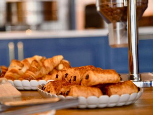 two plates of pastries sitting on a table at ibis Styles Nantes Reze Aéroport in Rezé