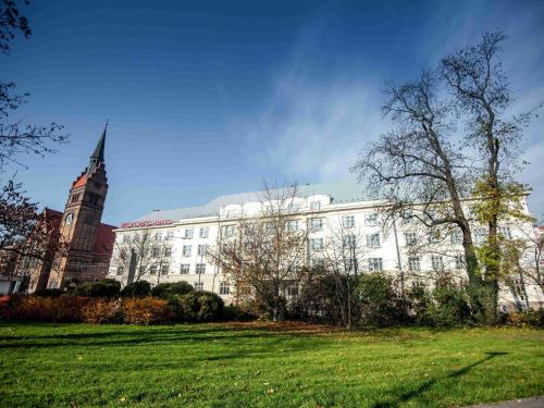 a white building with a steeple and a church at Mercure Ostrava Center in Ostrava