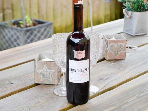 a bottle of wine sitting on a table at Ty Glyndwr in Ystalyfera