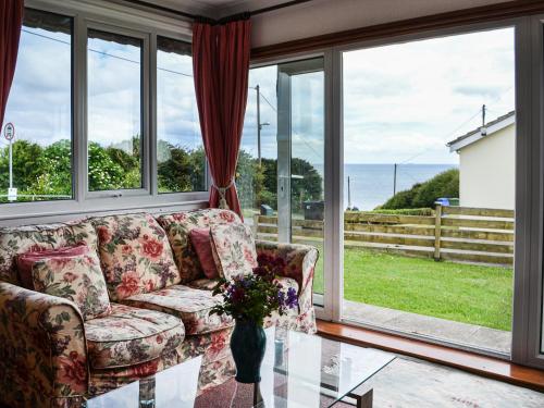 a living room with a couch and a glass table at Sunny Bank - Uk34711 in Reighton