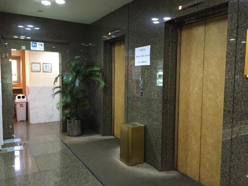 a lobby of a building with a door and a plant at Hotel Socia in Hita