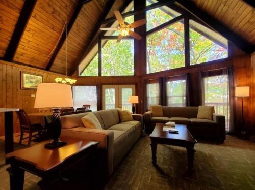 a living room with a couch and a ceiling fan at Gatlinburg Mountain Cabin with Modern Comforts in Chalet Village