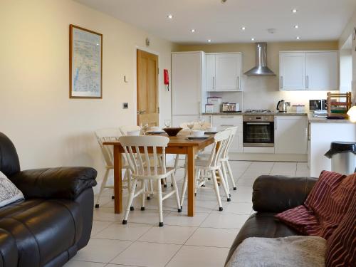 a kitchen and dining room with a table and chairs at Carribber Beech in Torphichen