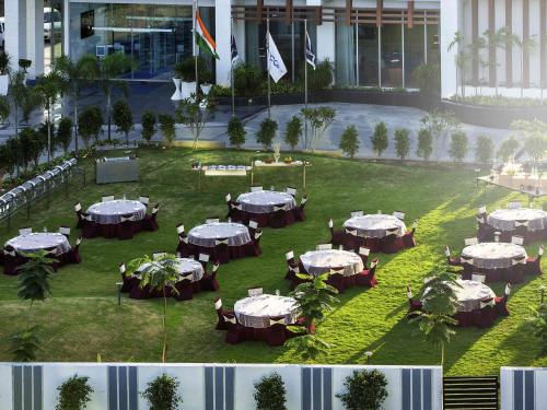 a group of tables in a field in a building at Novotel Chennai Sipcot in Chennai