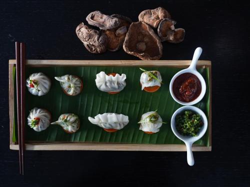 a plate of oysters and meat on a green leaf at Novotel Chennai Sipcot in Chennai