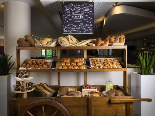 a bakery with lots of different types of bread at Novotel Chennai Sipcot in Chennai