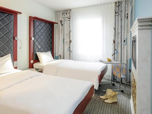 Postel nebo postele na pokoji v ubytování ibis Styles Hotel Berlin Mitte