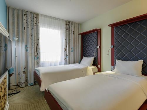 Postel nebo postele na pokoji v ubytování ibis Styles Hotel Berlin Mitte
