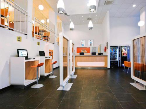 a lobby of a hospital with a desk and chairs at Ibis budget Wien Messe in Vienna