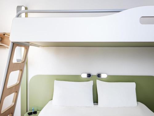 a bunk bed with two pillows in a room at Ibis budget Wien Messe in Vienna