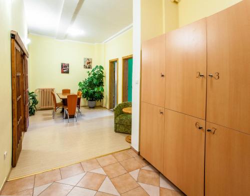 a hallway with wooden cabinets and a dining room at Hostel Terasa in Novi Sad