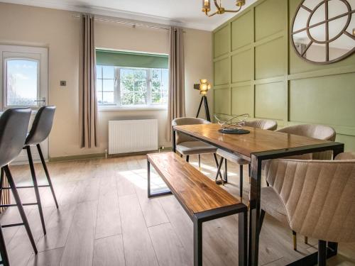 a dining room with a table and chairs at The Loans Inn Cottage in Loans