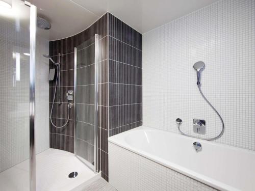 a bathroom with a shower and a bath tub at Novotel Suites Paris Issy Les Moulineaux in Issy-les-Moulineaux