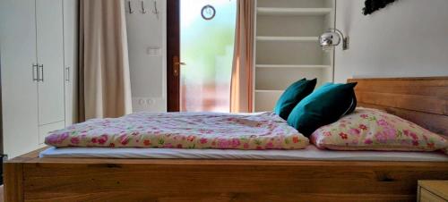 a bed with pillows sitting on top of it at Apartmán Slunečná in Moravská Třebová
