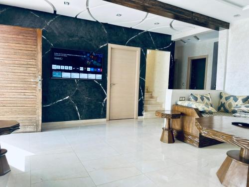 Un vestíbulo con una gran pared de mármol y una puerta. en Belle villa spacieuse et calme avec piscine à 7min de la plage en voiture, en Tamaris