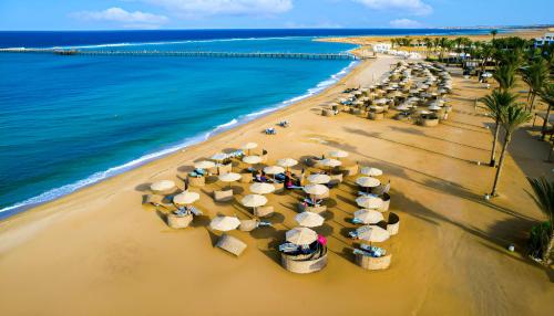 an overhead view of a beach with umbrellas and the ocean at Casa Mare Resort - ex, Royal Tulip Beach Resort in Port Ghalib