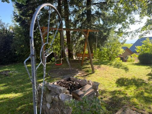 a playground with a swing in a yard at Alpina Löwen Hotel in Sankt Märgen