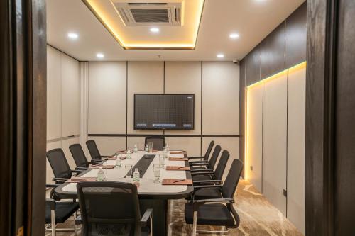 a conference room with a long table and chairs at Iconique Hotel Nha Trang in Nha Trang