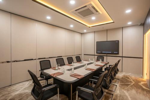 a conference room with a long table and chairs at Iconique Hotel Nha Trang in Nha Trang