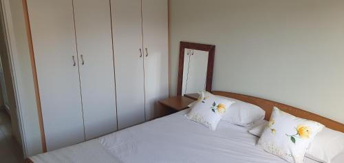 a bedroom with a bed with white sheets and pillows at Apartment 7 in Tisno