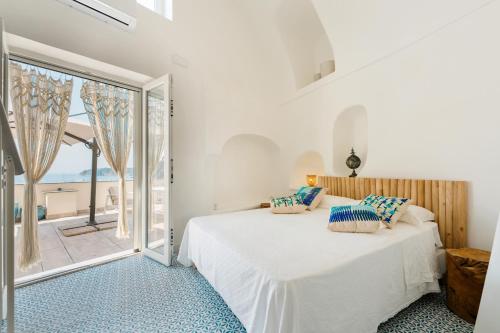 a bedroom with a bed and a large window at Stella di Mare in Procida
