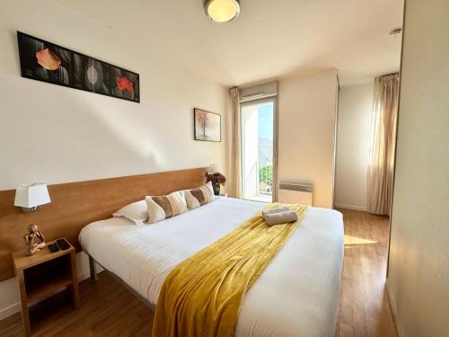 Ένα ή περισσότερα κρεβάτια σε δωμάτιο στο Le Saint Jean, Ouest de Rennes, avec balcon et stationnement