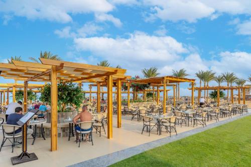 a patio at a restaurant with tables and chairs at Casa Mare Resort - ex, Royal Tulip Beach Resort in Port Ghalib