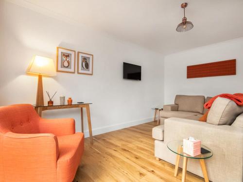 a living room with a couch and a table at Flat 1 in Inverness