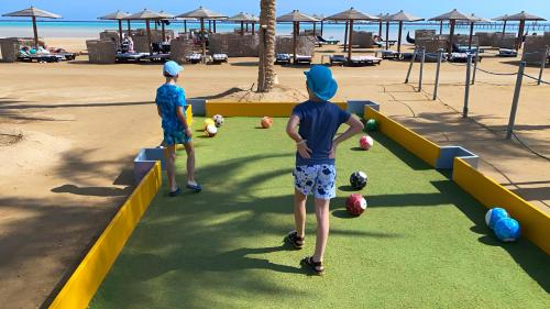 two young boys playing with balls on the beach at Casa Mare Resort - ex, Royal Tulip Beach Resort in Port Ghalib