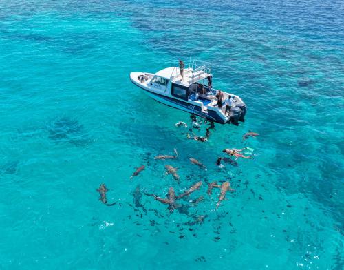 a group of people on a boat in the water at Ostrov Beach in Ukulhas