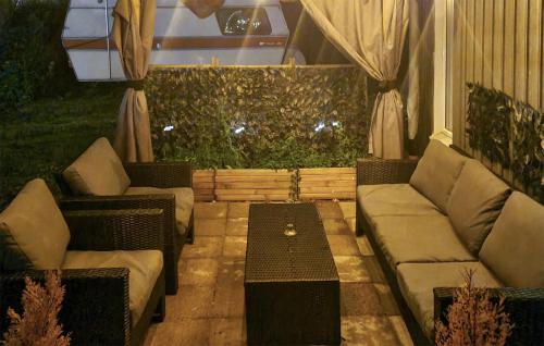 a patio with two couches and a coffee table at Amazing Home In Perstorp in Perstorp