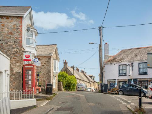 an empty street in a small town with a red phone booth at Upper Deck in Saint Erth