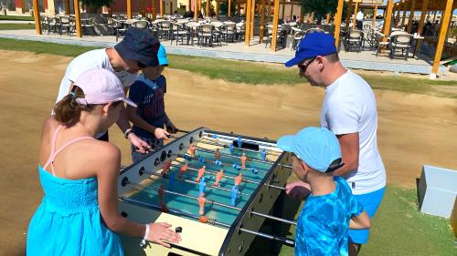 a group of people playing a game of dominoes at Casa Mare Resort - ex, Royal Tulip Beach Resort in Port Ghalib