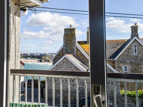 a window with a view of a building at Apartment 15 Harvest Moon in Newquay