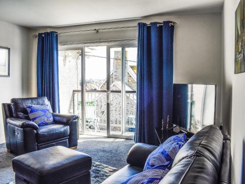 a living room with a couch and chairs and a window at Apartment 15 Harvest Moon in Newquay