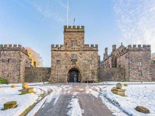 an old castle with snow on the ground at Irishman's Tower in Riley Green