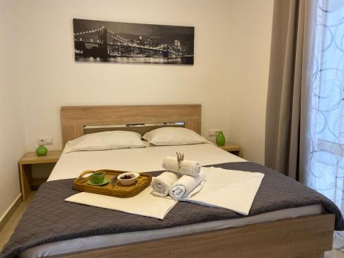 ein Bett mit einem Tablett mit Handtüchern und einer Brücke in der Unterkunft Junto al mar in Ulcinj