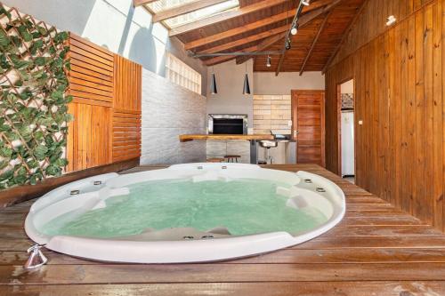 a large bath tub in a room with a kitchen at Chalés Mirante da Zimba in Imbituba