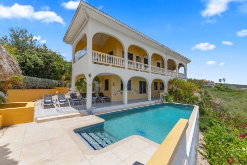 ein Haus mit einem Swimmingpool davor in der Unterkunft Villa Barbulete - Exclusive luxury sea view villa at Cas Abou in Dorp Soto