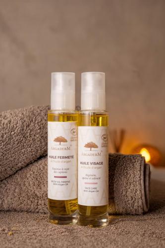 two bottles of hair products sitting on top of a towel at Dar Syada Boutique Hotel Marrakech in Marrakech